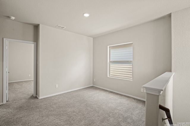 spare room with light colored carpet