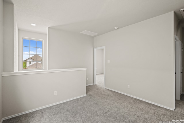 unfurnished room with light colored carpet