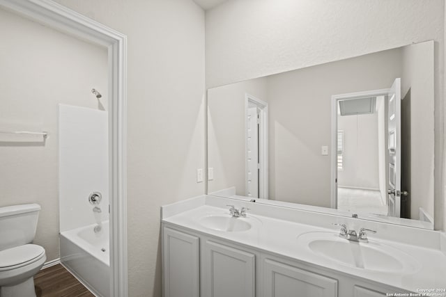 full bathroom featuring hardwood / wood-style floors, vanity, toilet, and shower / bath combination