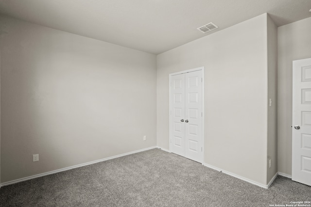 unfurnished bedroom featuring a closet and carpet