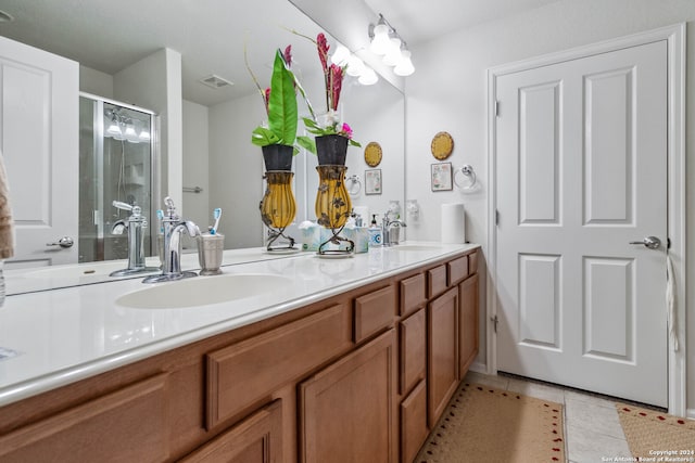 bathroom with tile patterned flooring, vanity, and an enclosed shower