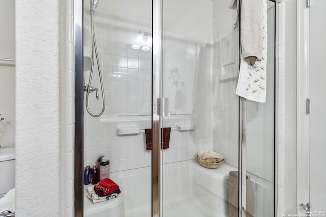 bathroom with toilet and walk in shower