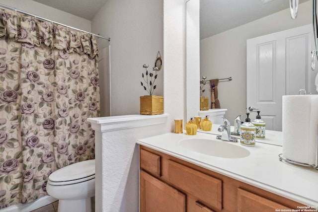 bathroom featuring vanity, toilet, and walk in shower