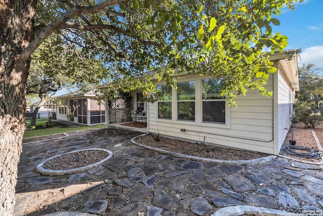 view of front facade featuring a patio and a sunroom