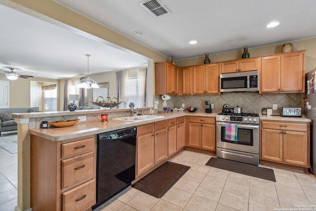 kitchen featuring kitchen peninsula, appliances with stainless steel finishes, light tile patterned floors, and sink