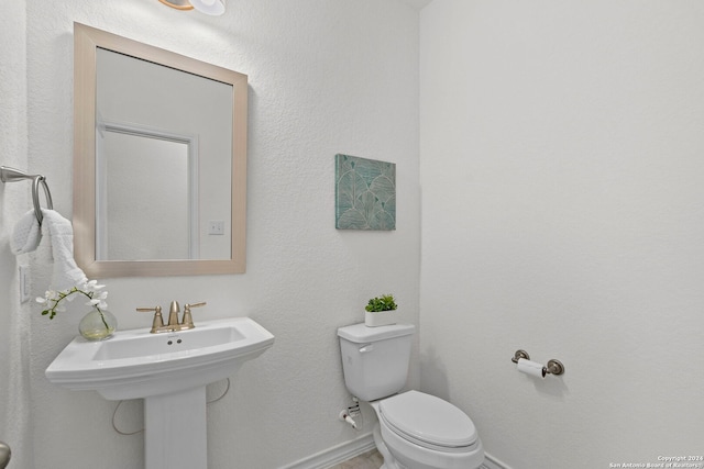 bathroom with toilet and sink