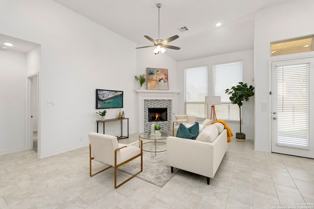 living room with light tile patterned floors, ceiling fan, and lofted ceiling