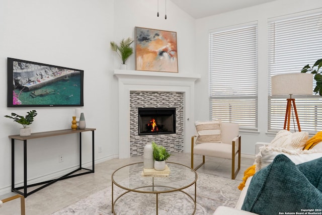 tiled living room featuring a fireplace and lofted ceiling