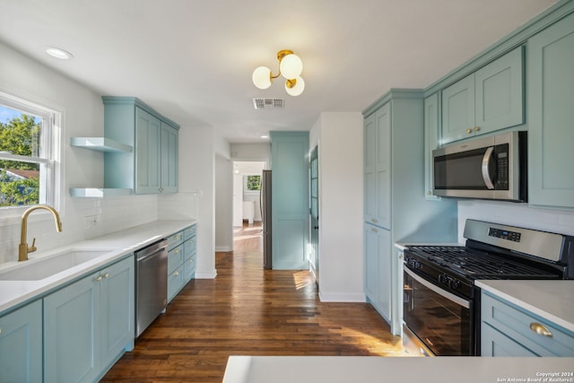 kitchen with tasteful backsplash, sink, dark hardwood / wood-style flooring, and stainless steel appliances