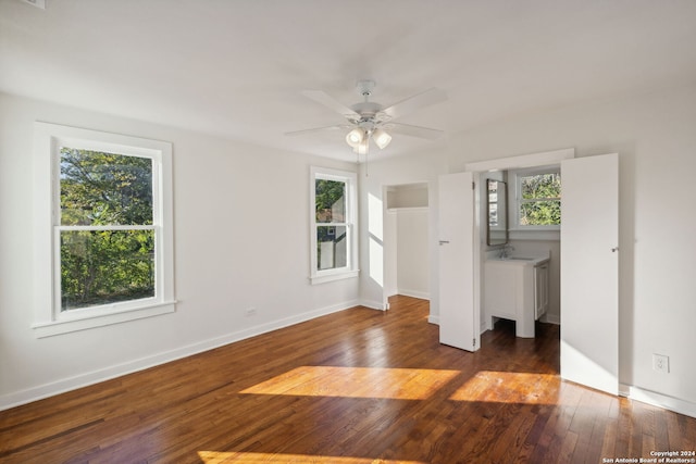 unfurnished bedroom featuring dark hardwood / wood-style flooring, sink, and ceiling fan