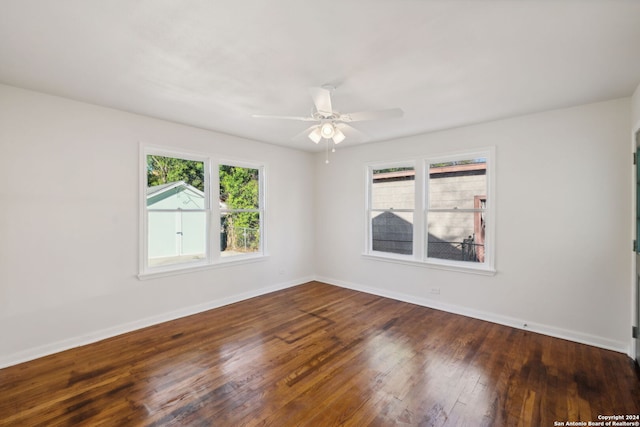 spare room featuring dark wood-type flooring and ceiling fan