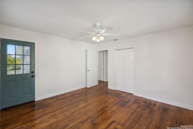 spare room with dark hardwood / wood-style floors and ceiling fan