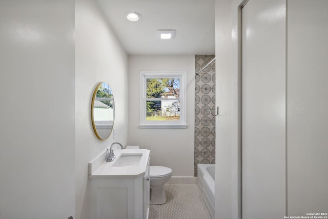 bathroom with vanity, tile patterned flooring, and toilet