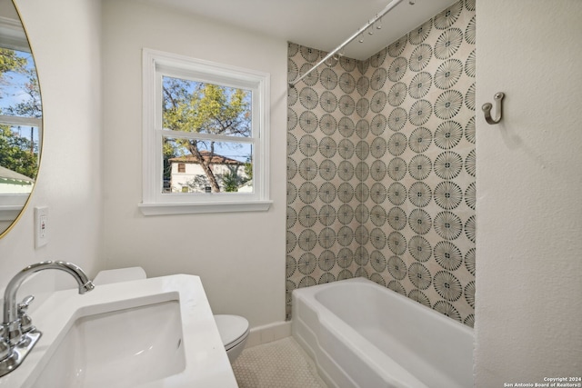 full bathroom featuring sink, tile patterned floors, shower / bathtub combination, and toilet