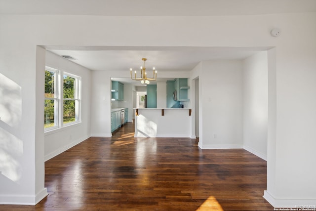 unfurnished dining area featuring dark wood-type flooring and a chandelier