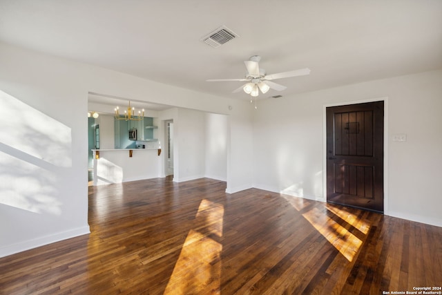 unfurnished room with dark hardwood / wood-style flooring and ceiling fan with notable chandelier