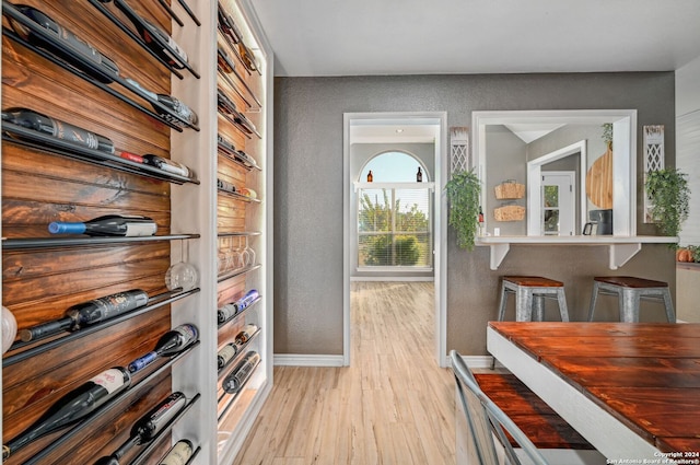 wine cellar with light hardwood / wood-style floors