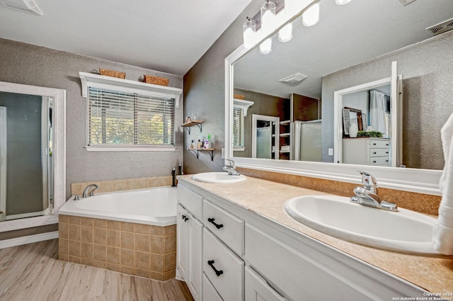 bathroom featuring vanity and shower with separate bathtub