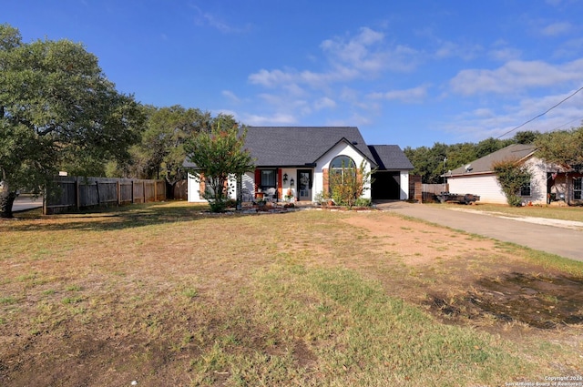 view of front of property featuring a garage and a front lawn