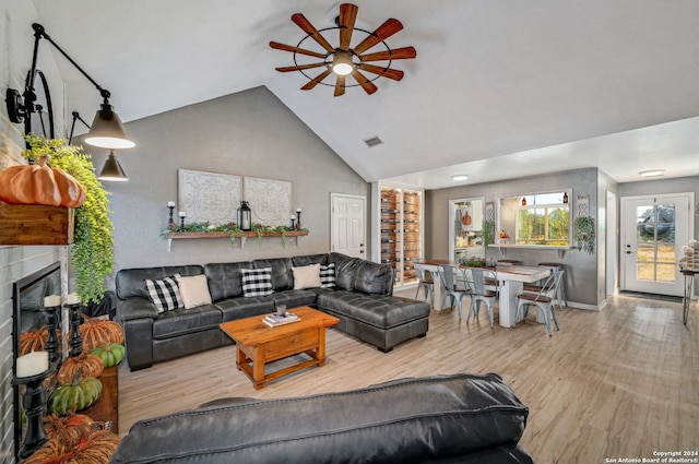 living room featuring light wood-type flooring, high vaulted ceiling, and ceiling fan