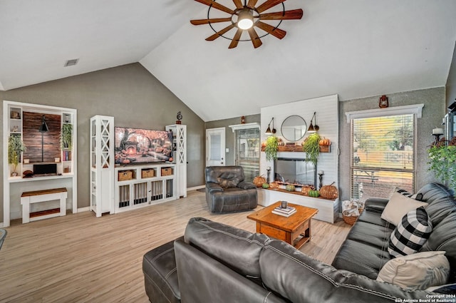 living room featuring vaulted ceiling, light hardwood / wood-style flooring, and ceiling fan