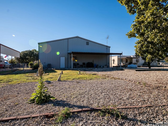 back of house with an outbuilding