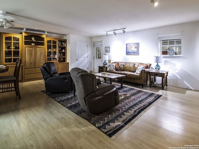 living room featuring ceiling fan and hardwood / wood-style flooring