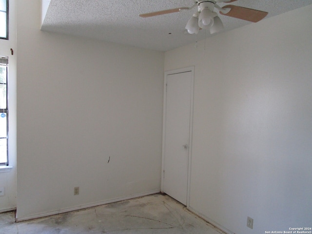 spare room with ceiling fan and a textured ceiling