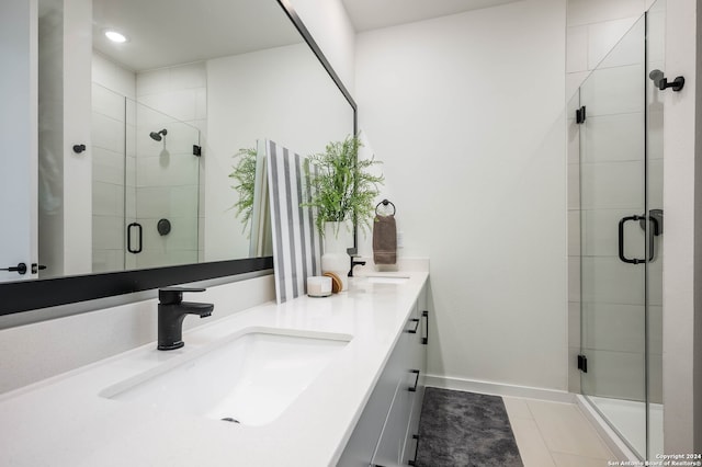 bathroom featuring vanity, tile patterned floors, and a shower with door