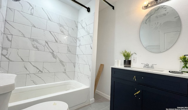 full bathroom featuring vanity, tiled shower / bath combo, and toilet