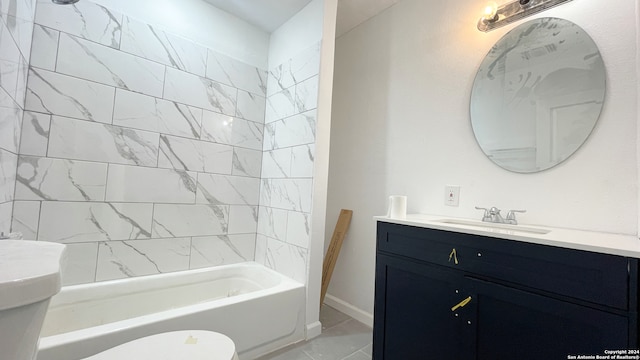 full bathroom with tiled shower / bath, vanity, and toilet