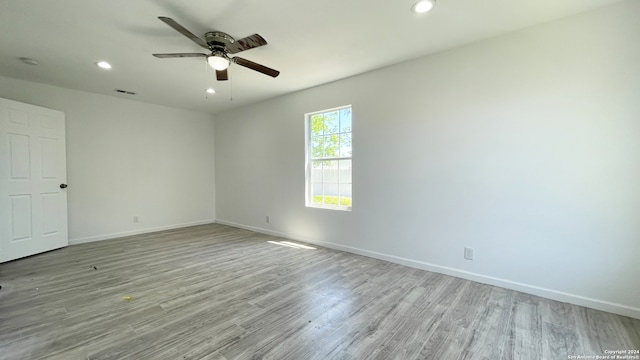 empty room featuring ceiling fan and light wood-type flooring