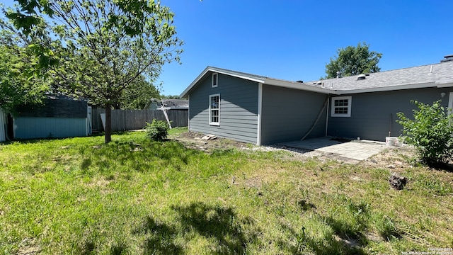 rear view of property with a lawn and a patio