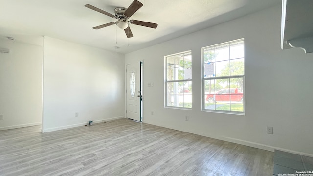 spare room featuring ceiling fan and light wood-type flooring