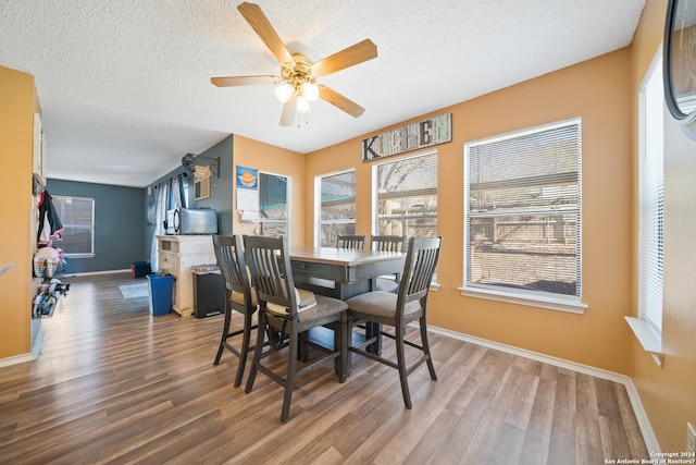 dining room featuring a textured ceiling, hardwood / wood-style flooring, and ceiling fan