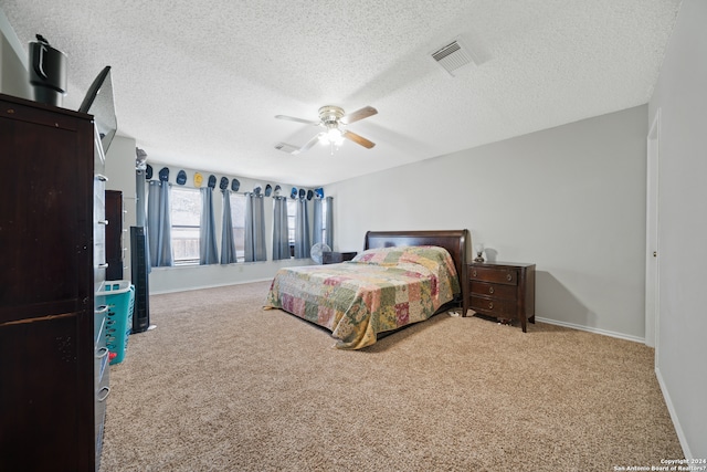 carpeted bedroom featuring a textured ceiling and ceiling fan