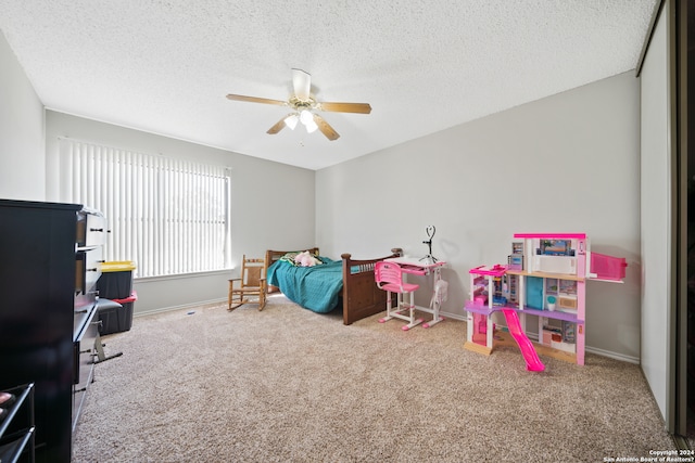 carpeted bedroom with a textured ceiling and ceiling fan