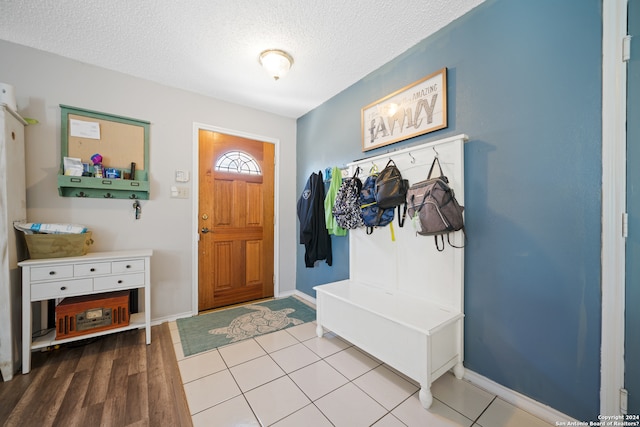 mudroom featuring wood-type flooring and a textured ceiling