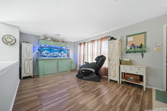 sitting room featuring hardwood / wood-style floors and a textured ceiling