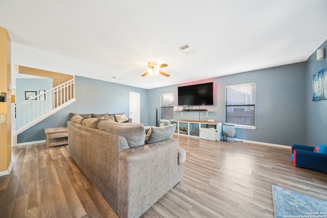 living room featuring ceiling fan and wood-type flooring