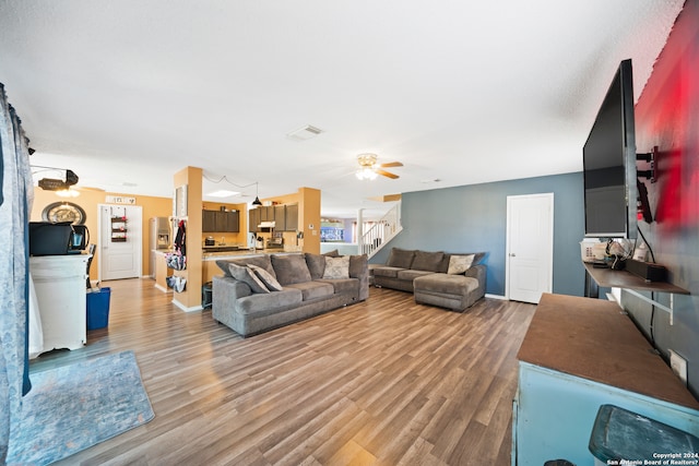 living room with hardwood / wood-style flooring and ceiling fan