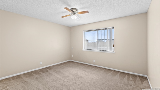 carpeted spare room with a textured ceiling and ceiling fan