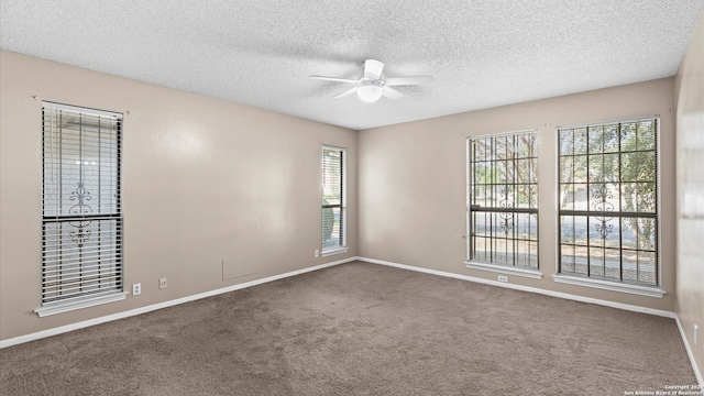 carpeted spare room featuring ceiling fan and a textured ceiling