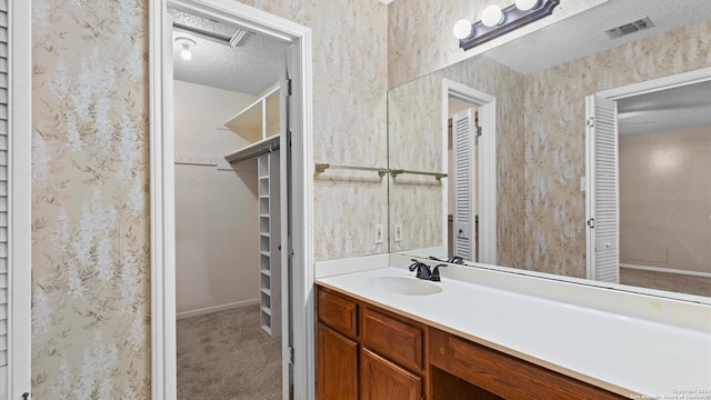 bathroom featuring vanity and a textured ceiling