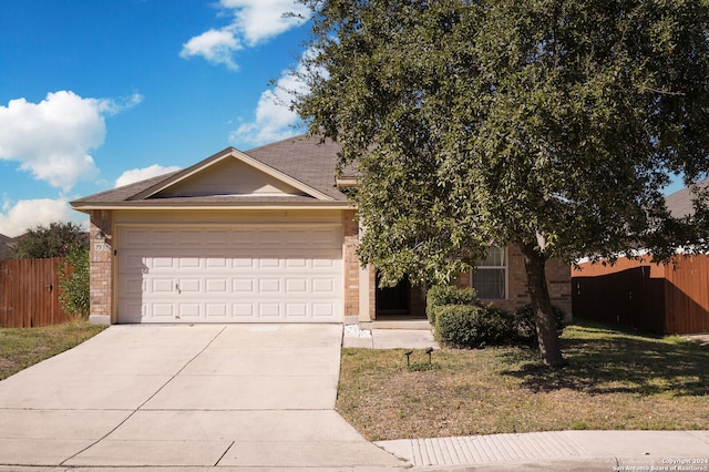 view of front of property with a front lawn and a garage