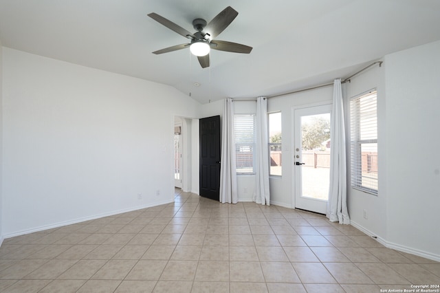 unfurnished room featuring ceiling fan, light tile patterned floors, and lofted ceiling