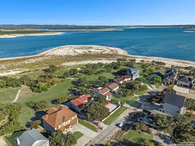 drone / aerial view featuring a water view and a beach view