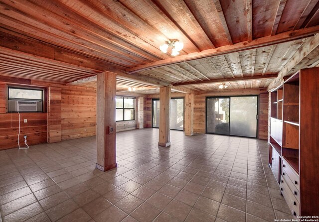 empty room featuring tile patterned floors, cooling unit, wood ceiling, and wooden walls