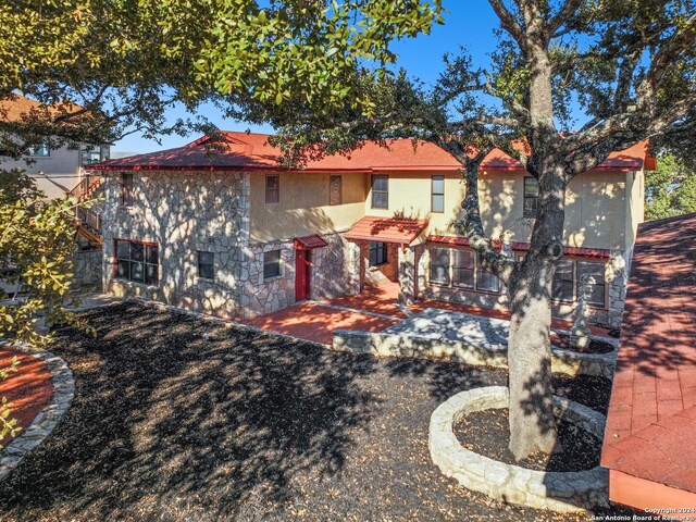 back of property with a patio