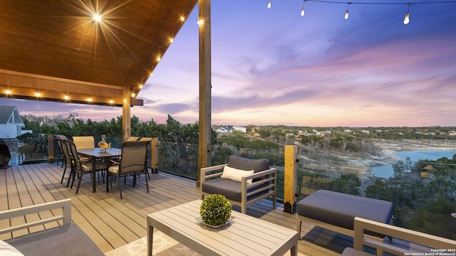 deck at dusk with an outdoor living space